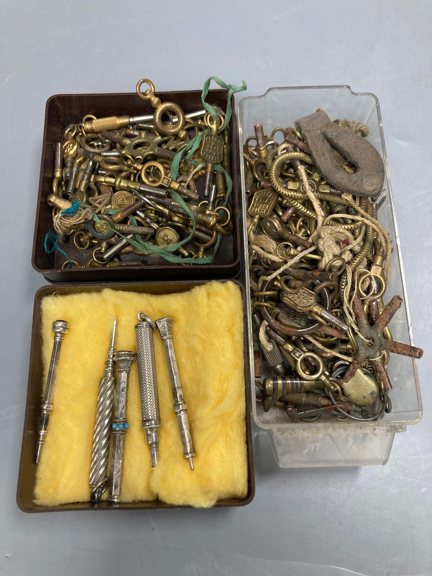 Five white metal propelling pencils and a collection of watch keys